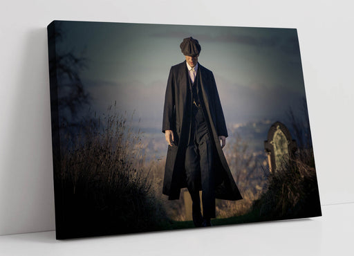 Man in a long coat and hat standing in a misty landscape on a canvas print.